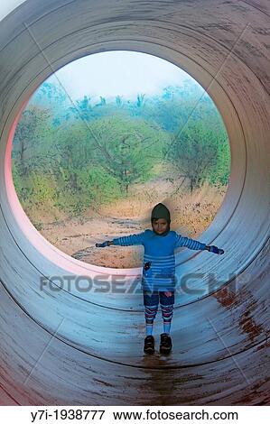 Little girl in a Huge Pipe, Pune, Maharashtra, India View Large Photo Image Stock Photo - Little girl in a Huge Pipe, Pune, Maharashtra, India. Fotosearch