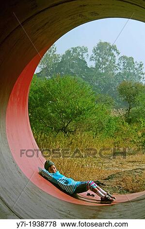 Little girl in a Huge Pipe, Pune, Maharashtra, India View Large Photo Image Stock Photo - Little girl in a Huge Pipe, Pune, Maharashtra, India. Fotosearch
