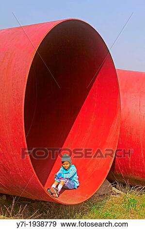 Little girl in a Huge Pipe, Pune, Maharashtra, India View Large Photo Image Stock Photo - Little girl in a Huge Pipe, Pune, Maharashtra, India. Fotosearch