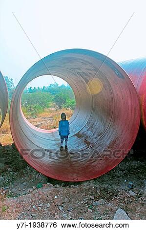 Little girl in a Huge Pipe, Pune, Maharashtra, India View Large Photo Image Stock Photograph - Little girl in a Huge Pipe, Pune, Maharashtra, India. Fotosearch
