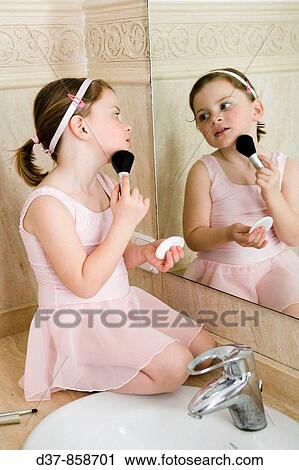 Little girl in ballet dress applying make up View Large Photo Image Stock Image - Little girl in ballet dress applying make up. Fotosearch