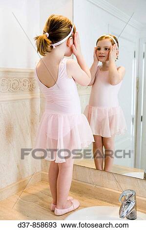 Little girl in ballet dress looking herself at the mirror View Large Photo Image Stock Image - Little girl in ballet dress looking herself at the mirror. Fotosearch
