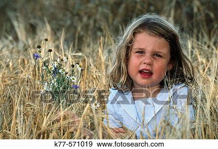 Little girl in grain field. Bornholm. Denmark View Large Photo Image Stock Photo - Little girl in grain field. Bornholm. Denmark. Fotosearch