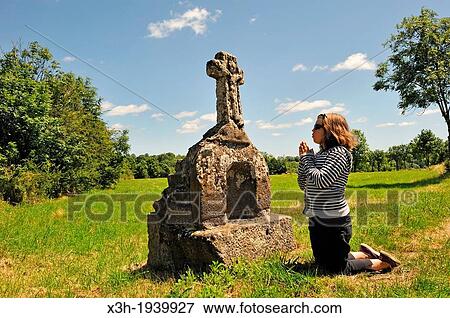 little girl in meditation in front of a stone cross, Cantal department, Auvergne region, France, Europe View Large Photo Image Stock Photo - little girl in meditation in front of a stone cross, Cantal department, Auvergne region, France, Europe. Fotosearch