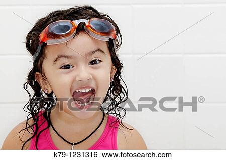 Little girl in swim suit and swim goggles with excited look on her face. View Large Photo Image Stock Photograph - Little girl in swim suit and swim goggles with excited look on her face.. Fotosearch