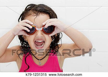 Little girl in swim suit and swim goggles with excited look on her face. View Large Photo Image Stock Photography - Little girl in swim suit and swim goggles with excited look on her face.. Fotosearch