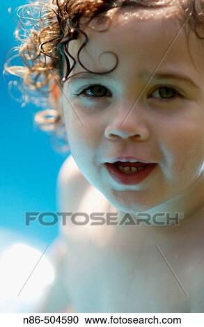 Stock Image - Little girl in swimming pool. Fotosearch