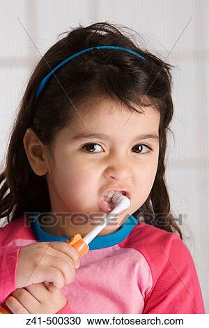Little girl is brushing her teeth View Large Photo Image Stock Image - Little girl is brushing her teeth. Fotosearch