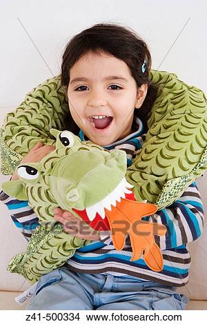 Little girl is with her toy dragon View Large Photo Image Picture - Little girl is with her toy dragon. Fotosearch