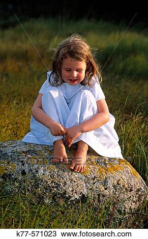 Little girl on a rock. Bornholm. Denmark View Large Photo Image Stock Image - Little girl on a rock. Bornholm. Denmark. Fotosearch