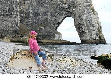 little girl on a shingle beach of Etretat, Cote d? Albatre, Pays de Caux, Seine-Maritime department, Upper Normandy region, France, Europe View Large Photo Image Stock Image - little girl on a shingle beach of Etretat, Cote d? Albatre, Pays de Caux, Seine-Maritime department, Upper Normandy region, France, Europe. Fotosearch
