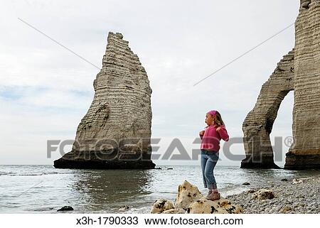 little girl on a shingle beach of Etretat, Cote d? Albatre, Pays de Caux, Seine-Maritime department, Upper Normandy region, France, Europe View Large Photo Image Stock Image - little girl on a shingle beach of Etretat, Cote d? Albatre, Pays de Caux, Seine-Maritime department, Upper Normandy region, France, Europe. Fotosearch