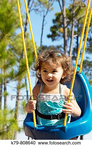 Little girl on swing. View Large Photo Image Stock Image - Little girl on swing.. Fotosearch