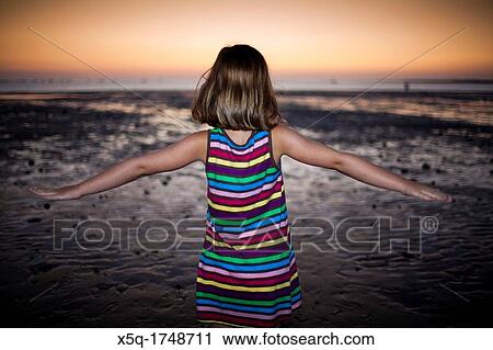 Little girl on the beach at dusk, Spain View Large Photo Image Stock Image - Little girl on the beach at dusk, Spain. Fotosearch
