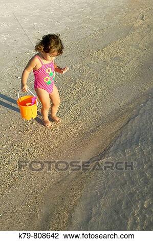 Stock Image - Little girl on the beach in Panama City Beach, Florida.. Fotosearch