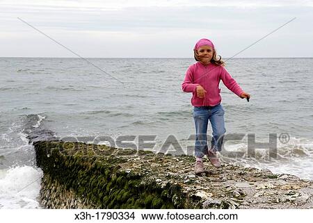 little girl on the beach of Etretat, Cote d? Albatre, Pays de Caux, Seine-Maritime department, Upper Normandy region, France, Europe View Large Photo Image Picture - little girl on the beach of Etretat, Cote d? Albatre, Pays de Caux, Seine-Maritime department, Upper Normandy region, France, Europe. Fotosearch