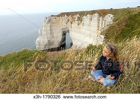 Stock Photograph - little girl on the top of cliff, Etretat, Cote d? Albatre, Pays de Caux, Seine-Maritime department, Upper Normandy region, France, Europe. Fotosearch