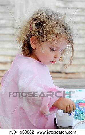 Little girl painting View Large Photo Image Stock Image - Little girl painting. Fotosearch
