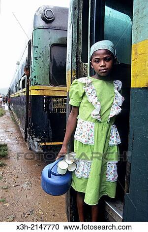 little girl peddling coffee in a station of the railway from Fianarantsoa to Manakara, Madagascar, Indian Ocean, Southeast Africa. View Large Photo Image Stock Image - little girl peddling coffee in a station of the railway from Fianarantsoa to Manakara, Madagascar, Indian Ocean, Southeast Africa.. Fotosearch