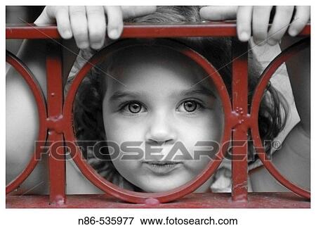 Little girl peering through fence View Large Photo Image Stock Photo - Little girl peering through fence. Fotosearch