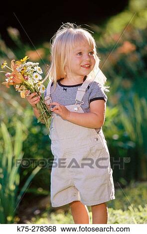 Little girl picking flowers View Large Photo Image Stock Photo - Little girl picking flowers. Fotosearch