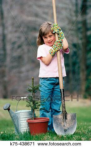 Stock Image - Little girl planting little tree. Fotosearch