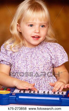 Little girl playing a keyboard View Large Photo Image Stock Photo - Little girl playing a keyboard. Fotosearch