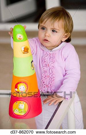 Little girl playing at home View Large Photo Image Stock Image - Little girl playing at home. Fotosearch
