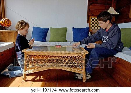 Little girl playing cards with her brother, Tarifa, Andalusia, Spain. View Large Photo Image Picture - Little girl playing cards with her brother, Tarifa, Andalusia, Spain.. Fotosearch