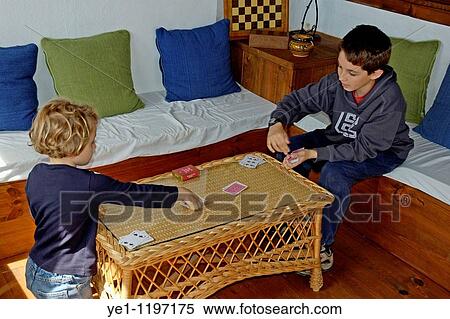 Little girl playing cards with her brother, Tarifa, Andalusia, Spain. View Large Photo Image Stock Photography - Little girl playing cards with her brother, Tarifa, Andalusia, Spain.. Fotosearch