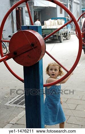 Little girl playing in an old hutong in Beijing, China. View Large Photo Image Stock Image - Little girl playing in an old hutong in Beijing, China.. Fotosearch