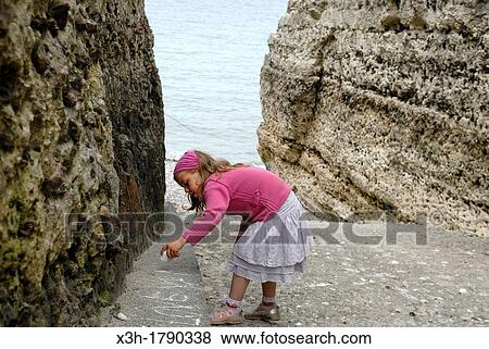 little girl playing on the beach of a valleuse, around Etretat, Cote d? Albatre, Pays de Caux, Seine-Maritime department, Upper Normandy region, France, Europe View Large Photo Image Stock Photo - little girl playing on the beach of a valleuse, around Etretat, Cote d? Albatre, Pays de Caux, Seine-Maritime department, Upper Normandy region, France, Europe. Fotosearch