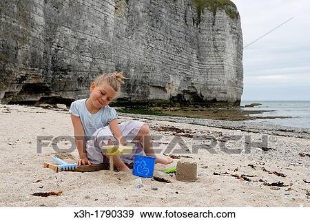 Stock Photo - little girl playing on the beach, valleuse of Vaucottes, around Etretat, Cote d? Albatre, Pays de Caux, Seine-Maritime department, Upper Normandy region, France, Europe. Fotosearch