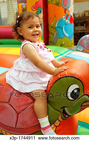 Stock Image - Little girl playing. Fotosearch