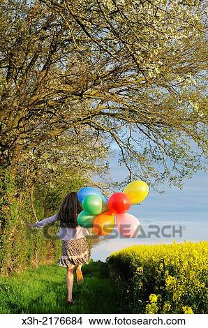 little girl playing with balloons in the fields, Eure-et-Loir department, Centre region, France, Europe. View Large Photo Image Picture - little girl playing with balloons in the fields, Eure-et-Loir department, Centre region, France, Europe.. Fotosearch