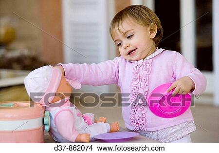 Little girl playing with dolls View Large Photo Image Picture - Little girl playing with dolls. Fotosearch