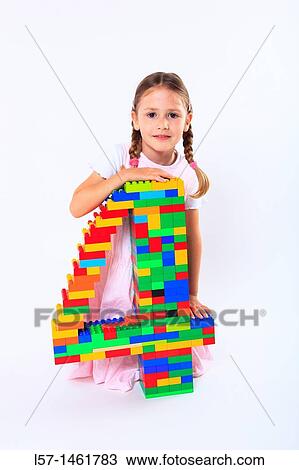 Stock Image - Little girl playing with Lego, Switzerland. Fotosearch