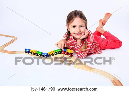 Little girl playing with wooden railway, Switzerland View Large Photo Image Stock Image - Little girl playing with wooden railway, Switzerland. Fotosearch