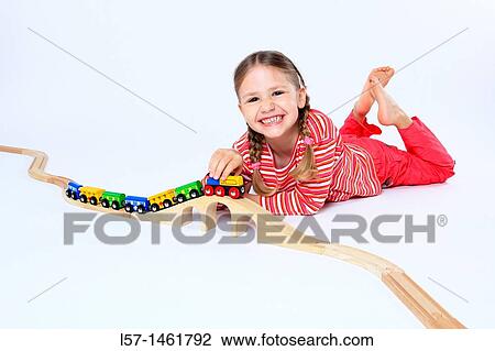 Little girl playing with wooden railway, Switzerland View Large Photo Image Stock Image - Little girl playing with wooden railway, Switzerland. Fotosearch