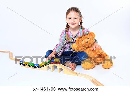Little girl playing with wooden railway, Switzerland View Large Photo Image Stock Image - Little girl playing with wooden railway, Switzerland. Fotosearch