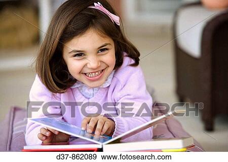 Stock Photo - Little girl reading a book. Fotosearch