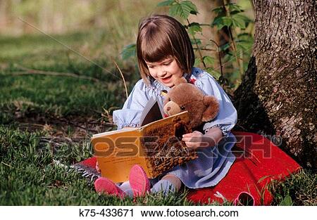 Little girl reading with her teddy bear View Large Photo Image Stock Image - Little girl reading with her teddy bear. Fotosearch