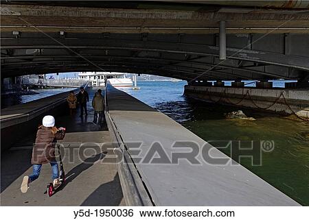 little girl riding scooter, pedestrian passage on Rhone river, under Mont Blanc bridge, Geneva, Switzerland. View Large Photo Image Stock Photograph - little girl riding scooter, pedestrian passage on Rhone river, under Mont Blanc bridge, Geneva, Switzerland.. Fotosearch