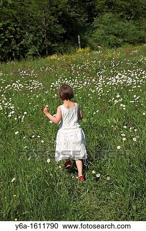 Little girl running across field rear view View Large Photo Image Stock Image - Little girl running across field rear view. Fotosearch