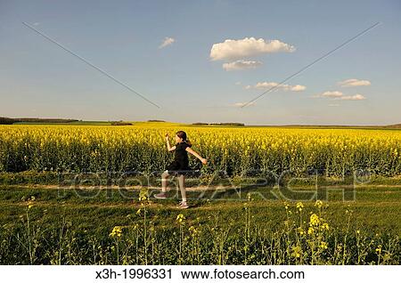 little girl running in blossoming fields of rapeseed, Senantes, Eure-et-Loir department, Centre region, France, Europe. View Large Photo Image Stock Image - little girl running in blossoming fields of rapeseed, Senantes, Eure-et-Loir department, Centre region, France, Europe.. Fotosearch