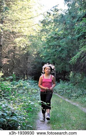 Stock Image - little girl running on a forest path, Allier department, Auvergne region, France, Europe. Fotosearch