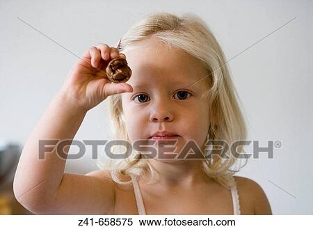 Little girl showing a bonbon View Large Photo Image Stock Photography - Little girl showing a bonbon. Fotosearch