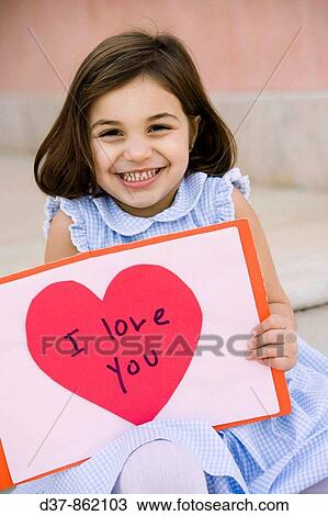 Little girl showing a poster with love View Large Photo Image Stock Image - Little girl showing a poster with love. Fotosearch