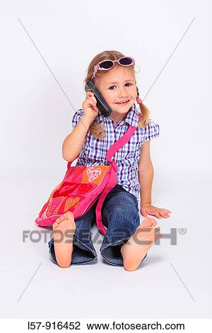little girl sitting with mobile phone and handbag over shoulder wearing sunglases, Switzerland View Large Photo Image Stock Image - little girl sitting with mobile phone and handbag over shoulder wearing sunglases, Switzerland. Fotosearch