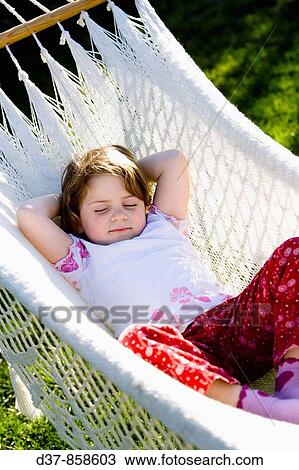 Stock Image - Little girl sleeping on a hammock. Fotosearch